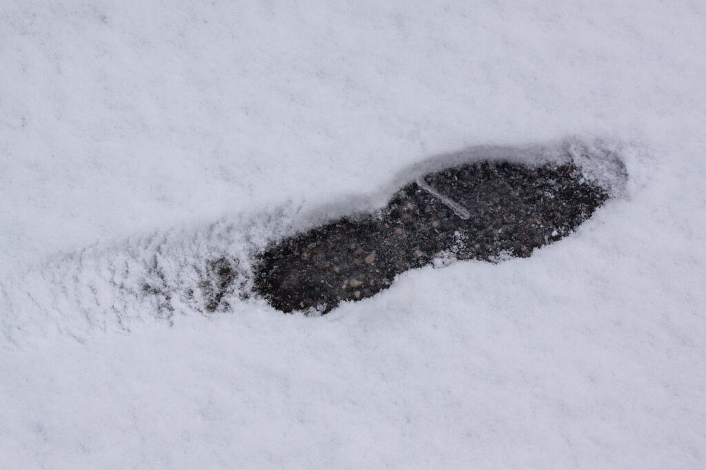 footprint in winter snow of asphalt paving contractors